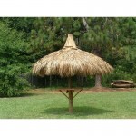 Single pole tiki hut with natural thatch and table